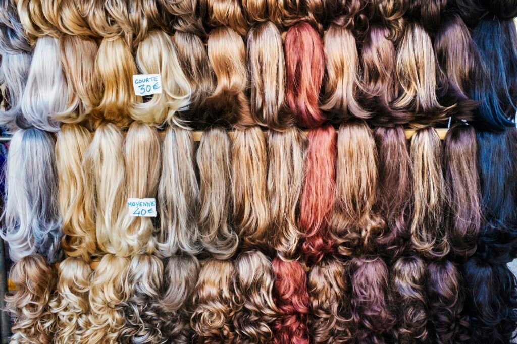 A display of hair extensions and hair pieces of different colours.